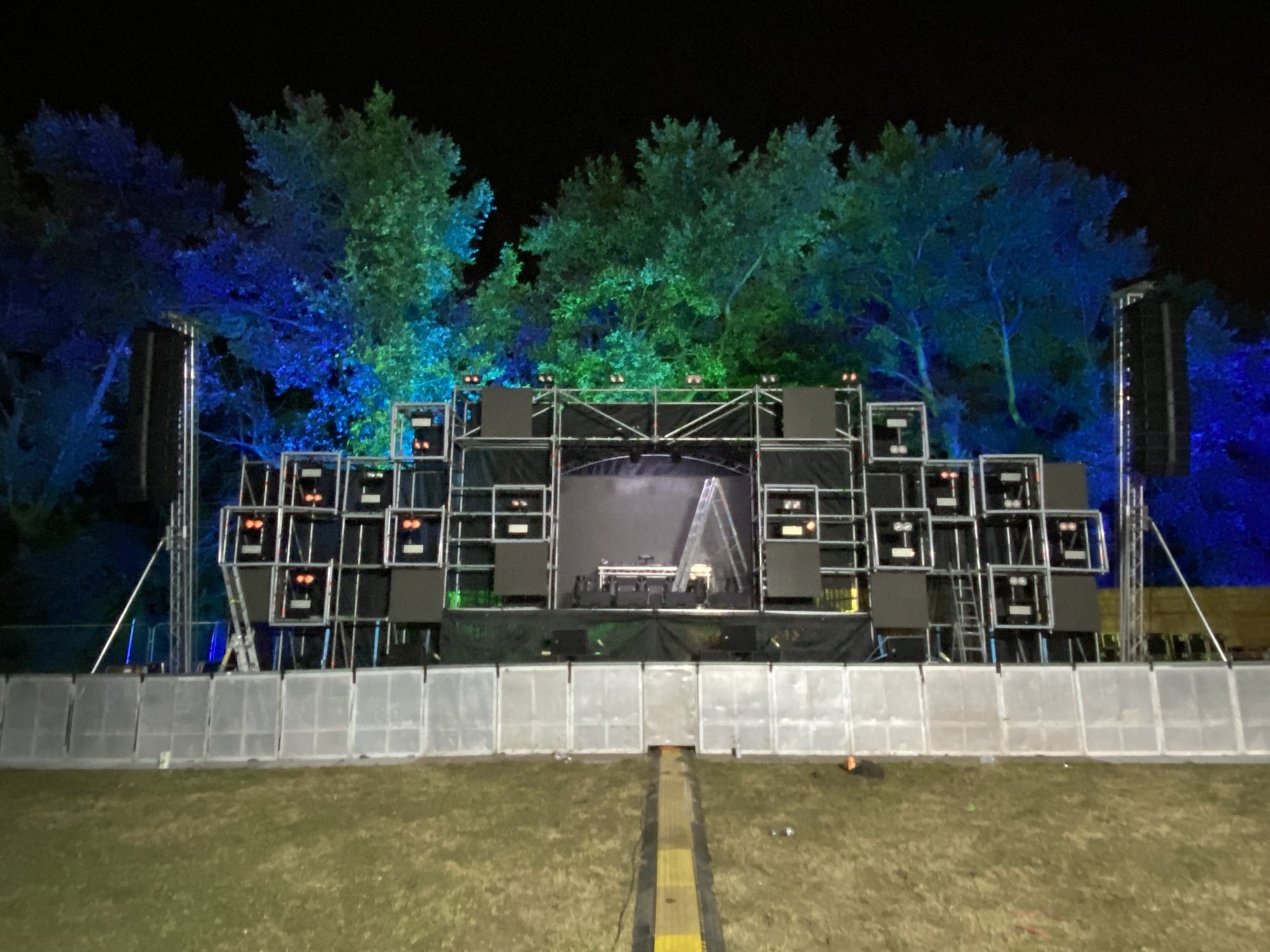 Festival main stage with LED, lit trees behind