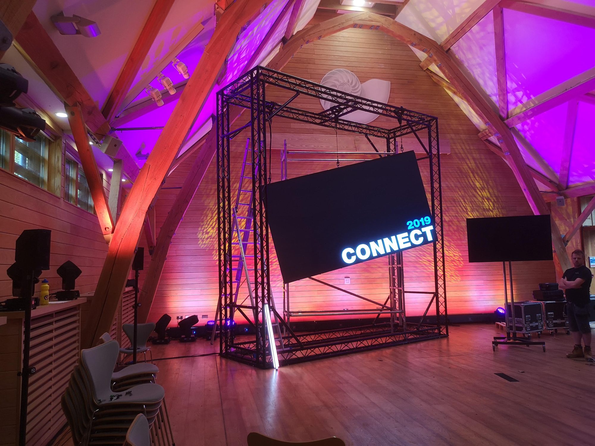 Flown screen in truss for a conference